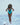 Model wearing open-back structured turquoise-red swimsuit.