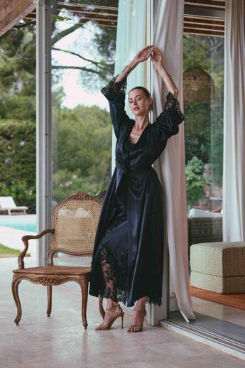 Black long silk satin dressing gown with lace-trimmed sleeves, guipure back, and waist tie for an elegant and sensual silhouette.