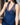 A navy blue chemise with lace detailing under the bust and a stretch-lace racerback, worn by a model.