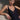 Model wearing the Branda one-piece swimsuit in black with floral embroidery and plunging neckline