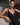 Model wearing the Branda one-piece swimsuit in black with floral embroidery and plunging neckline