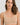 Classic seamless beige sports bra in soft ribbed fabric with light support and smooth fit, perfect for everyday comfort.