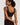 Classic seamless black sports bra in soft ribbed fabric with light support and smooth fit, perfect for everyday comfort.