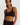 Classic seamless black sports bra in soft ribbed fabric with light support and smooth fit, perfect for everyday comfort.
