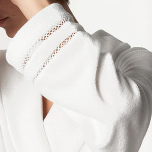 close-up detail of the Dahlia cotton knitted robe in white by Pluto showing the sleeve trim and knit texture