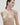 Essentiel nude seamless strapless bra with underwire and molded cups, microfiber comfort, and multi-way straps for versatile styling.