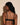 Forte black wireless bralette with French floral lace, plunge neckline, scalloped edges, and soft triangle cups for a bold, feminine look.