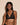 Forte black wireless bralette with French floral lace, plunge neckline, scalloped edges, and soft triangle cups for a bold, feminine look.