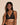 Forte black wireless bralette with French floral lace, plunge neckline, scalloped edges, and soft triangle cups for a bold, feminine look.