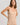 HANRO beige seamless V-neck camisole in mercerized cotton with satin trim and adjustable straps, perfect for layering or wearing alone.