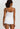 HANRO white seamless V-neck camisole in mercerized cotton with satin trim and adjustable straps, perfect for layering or wearing alone.