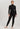 Model wearing Hanro Woolen Silk Long Leg in black with matching turtleneck