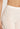 Close-up of Hanro Woolen Silk Long Leg in white showing fine wool-silk knit and satin waistband
