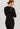 Back view of model wearing a women’s wool-silk long-sleeve thermal top in black by Hanro.