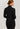 Back view of model wearing Hanro Woolen Silk Turtleneck in black showing seamless construction and sleek silhouette