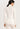 Back view of model wearing Hanro Woolen Silk Turtleneck in white showing seamless construction and sleek silhouette
