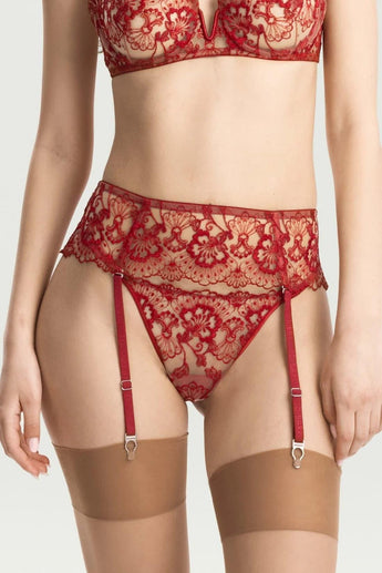 Close-up of red floral lace suspender belt with adjustable garter straps and metal clips