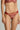 Model wearing the Memories of Love thong by I.D. Sarrieri in dark red showing embroidered lace design