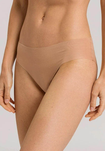 Invisible cotton beige hi-cut brief with seamless fit, ultra-flat edges, and breathable cotton-elastane blend for everyday comfort.
