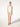 model wearing the Jamaika string body in white by Wolford with a scoop neckline and seamless fit