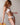 Marie Jo Rio briefs in white with feather-light fabric, seamless back, Brazilian cut, and elegant pearl strap detail.