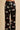 Close-up of the Olivia von Halle Lila Rene Black Blossom silk pajama pants featuring the exclusive Blossom floral print on black 19 momme silk satin.