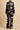 Back view of the Olivia von Halle Lila Rene Black Blossom silk pajama set showcasing the elegant Blossom floral print on black silk satin with ivory piping.