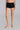 Model wearing Oscalito Silk Middle Rise Panties with Leavers Lace in black showing lace trim and rib-knit fabric