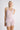 Model wearing Oscalito wool and silk lace tank top in rose showing lace neckline.