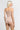 Back view of model wearing Oscalito wool and silk V-neck camisole in beige with satin trim highlighting seamless construction.