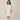 Model wearing Pluto Ebba Cotton Gown in ivory showing long sleeves and lace pocket detail