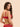 Back view of model wearing the Simone Pérèle Intrigue sheer embroidered demi cup bra in opera red featuring adjustable straps and a sheer tulle back band.