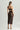 Woman wearing Tokyo Evenings black lace skirt with matching bralette, back view