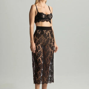Woman wearing Tokyo Evenings black lace skirt with matching bralette