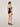 Back view of black forming bodysuit showing adjustable strap closure and seat coverage