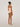 Back view of rose tan forming bodysuit showing adjustable strap closure and seat coverage