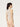 Back view of the Wolford Infinite Rose Net String Body in cream, showcasing the seamless floral net construction, sleeveless silhouette, thong back, and fitted design.