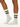 Model wearing Wolford Logo Ribbed Socks in white showing ribbed texture and blac logo detail around ankle