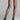 Back view of model wearing Wolford Individual 10 Back Seam Tights in black showing classic back seam and waistband logo