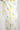 Close-up of yellow piping seam where pajama top meets matching pants, both in tennis ball print