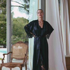 Black long silk satin dressing gown with lace-trimmed sleeves, guipure back, and waist tie for an elegant and sensual silhouette.