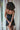 Black short silk dress with lace trim and adjustable straps, offering an elegant silhouette with sensual, fluid comfort and refined detail.