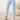 Close-up of pale blue joggers with drawstring waistband, button placket, and banded cuffs