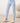 Close-up of pale blue joggers with drawstring waistband, button placket, and banded cuffs