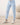 Close-up of pale blue joggers with drawstring waistband, button placket, and banded cuffs