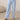 Close-up of pale blue wide leg lounge pants with elastic drawstring waistband and brushed fabric texture