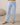 Close-up of pale blue wide leg lounge pants with elastic drawstring waistband and brushed fabric texture