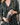 Model wearing Aspen Dream Grace Long Pajama Set in Martini with button-down top in a kitchen holding a cocktail shaker.