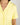 Close-up of notch collar, chest pocket, and button placket on buttery yellow pajama top with ruffled piping trim