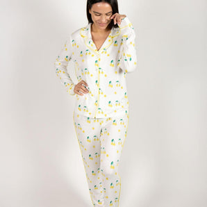 Ivory long-sleeve pajama top and matching pants with yellow tennis ball print and yellow piping, notch collar